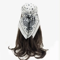 Close-up of black and white paisley pattern scarf tied on hair as a stylish headband - White Paisley Star (RZ7069)