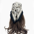 Detail of grey paisley headscarf with carriage print tied as a stylish hair accessory - Light Gray Coach Print (RZ6528)