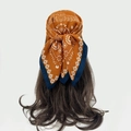 Detail of bohemian paisley bandana tied on hair showing caramel orange and navy patterns - Caramel Orange Paisley (RZ7024)