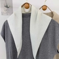 Detail of soft gray knit top paired with a creamy white triangular knitted scarf - White