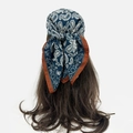 Detail of navy blue paisley silk scarf tied as a headband with contrast red borders - Paisley Contrast Style (RZ6554) / Navy Blue (RZ6554-Blue)