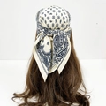 Detail of paisley print cotton square scarf in cream and navy blue worn as a headpiece - Cream White Paisley (RZ6558)
