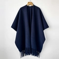 Detailed view of the soft fabric texture and long fringe on this navy blue cashmere-like shawl - Dark Blue