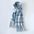 Detailed view of the soft mohair texture and long tassels on the blue plaid scarf - Light Blue