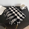 Detail of black and white checkered scarf with fringe and minimalist letter M label - Black and White