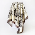 Detailed view of large floral print on 90cm satin silk scarf with premium brown border - Light Yellow