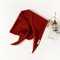 Flat lay of red 100% pure wool triangular knitted scarf with Aesop prop and magazine - Orange Red