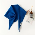 Detail view of soft blue 100% wool triangle scarf with premium woven material label - Sapphire Blue