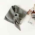 Detailed view of the 100% wool label on a gray knitted triangle scarf with soft texture - Light Gray