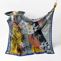 Artistic square silk scarf with floral bamboo print in vibrant orange and green hues - Bamboo and Flowers
