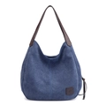Navy blue canvas tote bag with brown leather straps and square logo patch details - Dark Blue