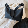 Black pebbled leather crescent bucket bag with braided strap and silver metal rivets - Black