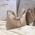 Minimalist beige tote bag featuring a woven leather strap and polished silver buckle details - Dark Khaki