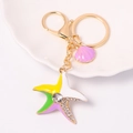 Cute colorful starfish keychain with rhinestones and a purple shell on a white plate - Starfish 12