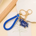 Detail of blue enamel horse keychain with gold hardware and braided leather strap - Leather Rope Pendant / Blue