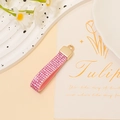 Detail of pink rhinestone leather strap with golden ring on a decorative white tray - Pink