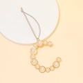 Detailed view of a gold-plated letter C keychain pendant with elegant white pearls - Letter C / Gold