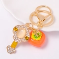 Gouden sleutelhanger met kristallen persimmon bedeltje en diamanten sleutel hanger - Kaki Geel