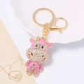 Dettaglio portachiavi a forma di bue rosa con cristalli e finiture in metallo oro - Pendaglio Mucca Cartoon Strass (Rosa) / Rosa