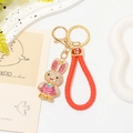 Detail of a sparkling rhinestone rabbit keychain with red woven strap and lucky charm - Red Rope + Pink Rhinestone Rabbit