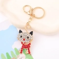 Detailed close-up of golden cat keychain with sparkling crystals and lobster clasp - Red