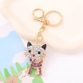 Detailed view of cat keychain with white and purple rhinestones and golden lobster clasp - Deep purple