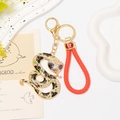 Porte-clés serpent doré avec émail vert, cristaux et lanière en similicuir tressé rouge - Style Noir Vert avec Corde Rouge