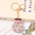 Porte-clés sac de fortune doré avec strass scintillants et détails floraux en émail rose - Style Fleur Rose Et Verte