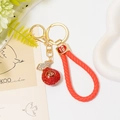 Detail of Chinese lucky bag keychain with red crystals and woven red leather lanyard - Red Lucky Bag with Red Leather Rope
