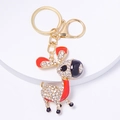 Detail of deer keychain with gold alloy base and sparkling rhinestones on white stand - Red Style