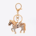 Golden horse zodiac keychain encrusted with white rhinestones and a lobster clasp - White Zirconia Style