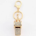Macro detail of golden whistle keychain with sparkling rhinestones and lobster clasp - Clear Rhinestone Whistle Keychain / Gold