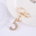Creatieve gouden sleutelhanger nummer 5 met fonkelende steentjes en een karabijnhaak - Cijfer 5