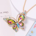 Macro shot of colorful rhinestone butterfly pendant with rainbow crystals on gold chain - Necklace / Rainbow