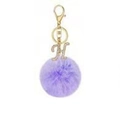 Close-up of purple faux fur ball keychain with gold lobster clasp and rhinestone letter H - Letter H / Purple