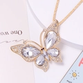 Macro shot of butterfly pendant with crystal wings and gold-plated alloy details - Necklace / White