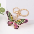 Portachiavi a farfalla con strass colorati e chiusura a moschettone dorata su bianco - Multicolore Rosa Verde