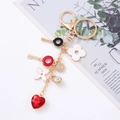 Golden alloy four-leaf clover keychain with sparkling heart and rhinestone charms - Black