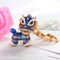 Blauwe strass leeuwendans sleutelhanger met gouden legering en parelaccenten - Blauw