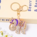 Detailed close-up of golden elephant keychain with purple enamel and white rhinestones - Purple Enamel Hollow Crown Elephant (Color 4@)
