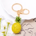 Detailed view of yellow rhinestone pineapple keychain with golden ring and lobster clasp - Pineapple