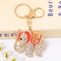 Detailed close-up of golden elephant keychain with sparkling rhinestones and red enamel - Red Enamel Pave Diamond Crown Elephant (Color 4)
