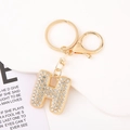 Macro detail of gold letter H keychain featuring sparkling rhinestones and lobster clasp - Letter H