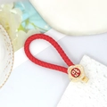 Roter geflochtener Schlüsselanhänger mit goldenem Strass-Blumenanhänger und Glückssymbol - Rote Lederschnur