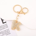 Macro shot of letter K gold keychain with sparkling rhinestones and lobster clasp - Letter K
