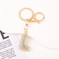 Detail of crystal letter L keychain with sparkling rhinestones and golden hardware - Letter L
