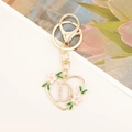 Detailed view of a gold heart keychain with sparkling letter D and floral enamel charms - Letter D Style