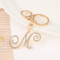 Elegant gold alphabet M keychain with sparkling rhinestones on a decorative tray - Letter M(M) / Gold