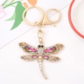 Golden dragonfly keychain with colorful rhinestones and crystals on white background - Gradient Iridescent Rhinestone Style