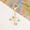 Close-up of heart-shaped gold keychain with letter Y and sparkling rhinestones - Letter Y Style